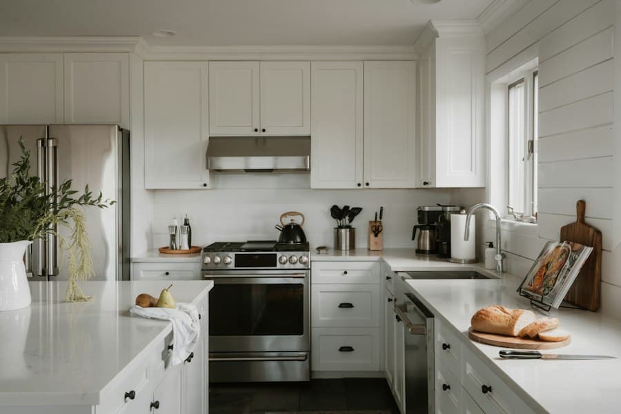 A bright kitchen with clear, freshly wiped benchtops and white cabinetry
